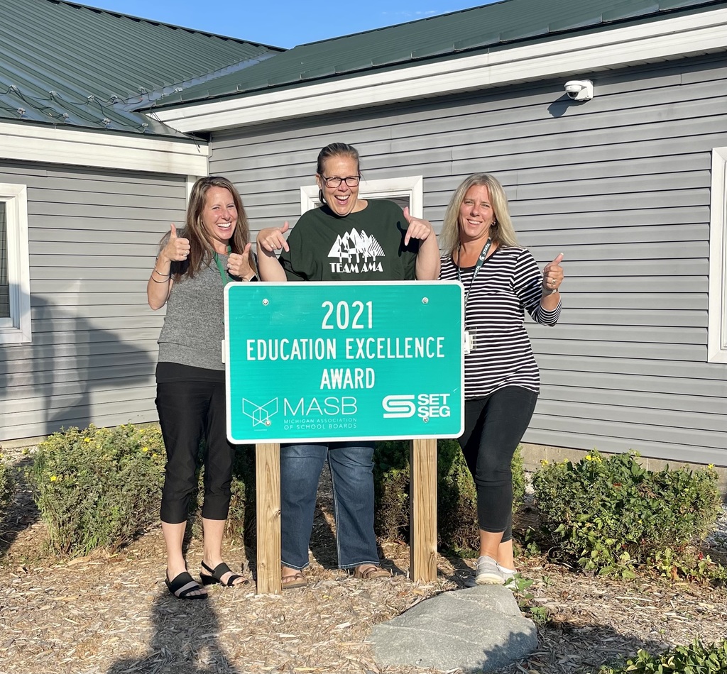 Three therapists by 2021 excellence award sign with thumbs up!