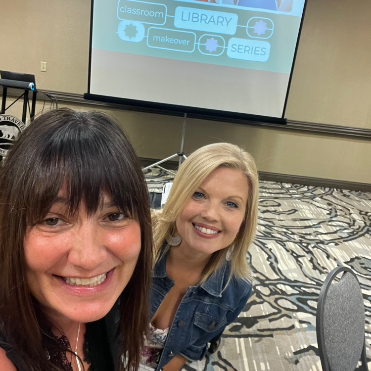 two facilitators in front of presentation screen